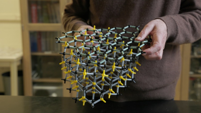 hands holding molecular model