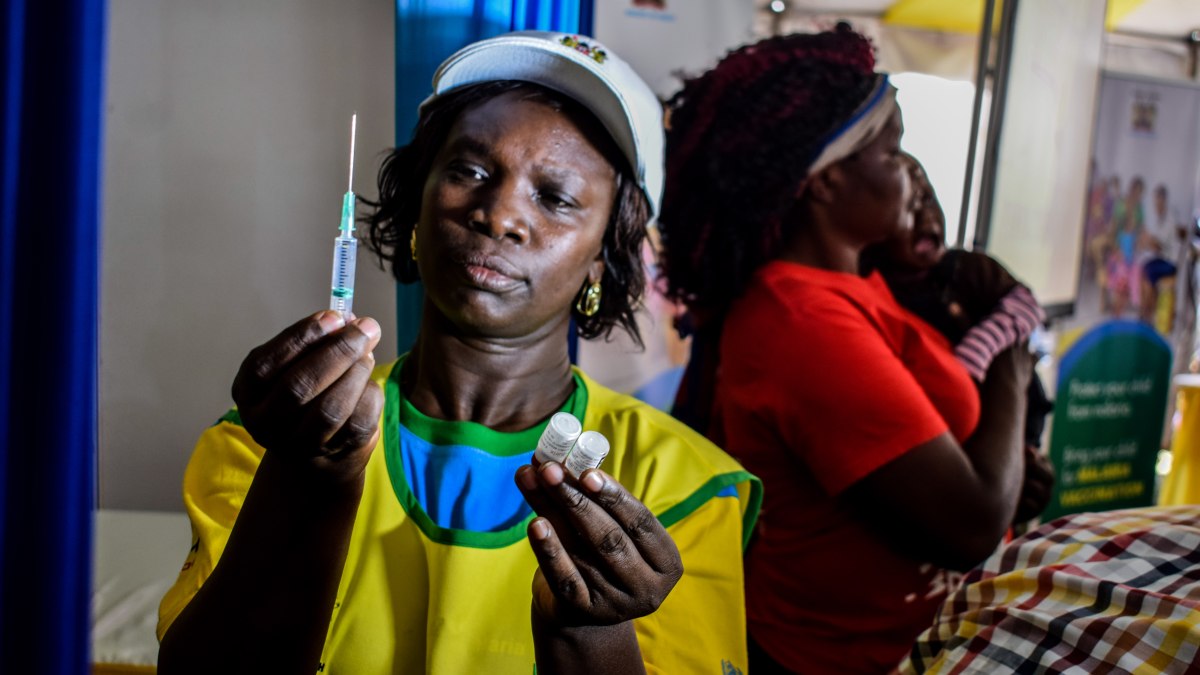 A health worker mixes vaccine during the launch of Malaria vaccine pilot programs in Kenya.