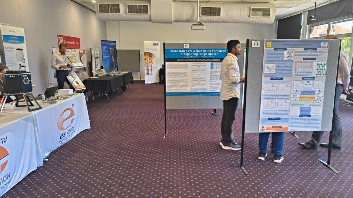 physicists talking about posters at conference