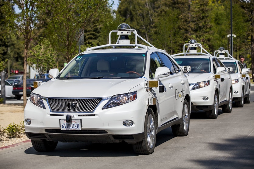 Photograph of google self-driving cars with lidar scanner on roof