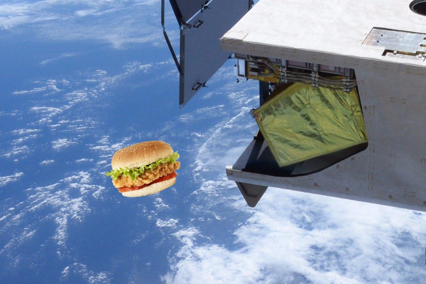 Artist's impression of a chicken burger in orbit next to the International Space Station.