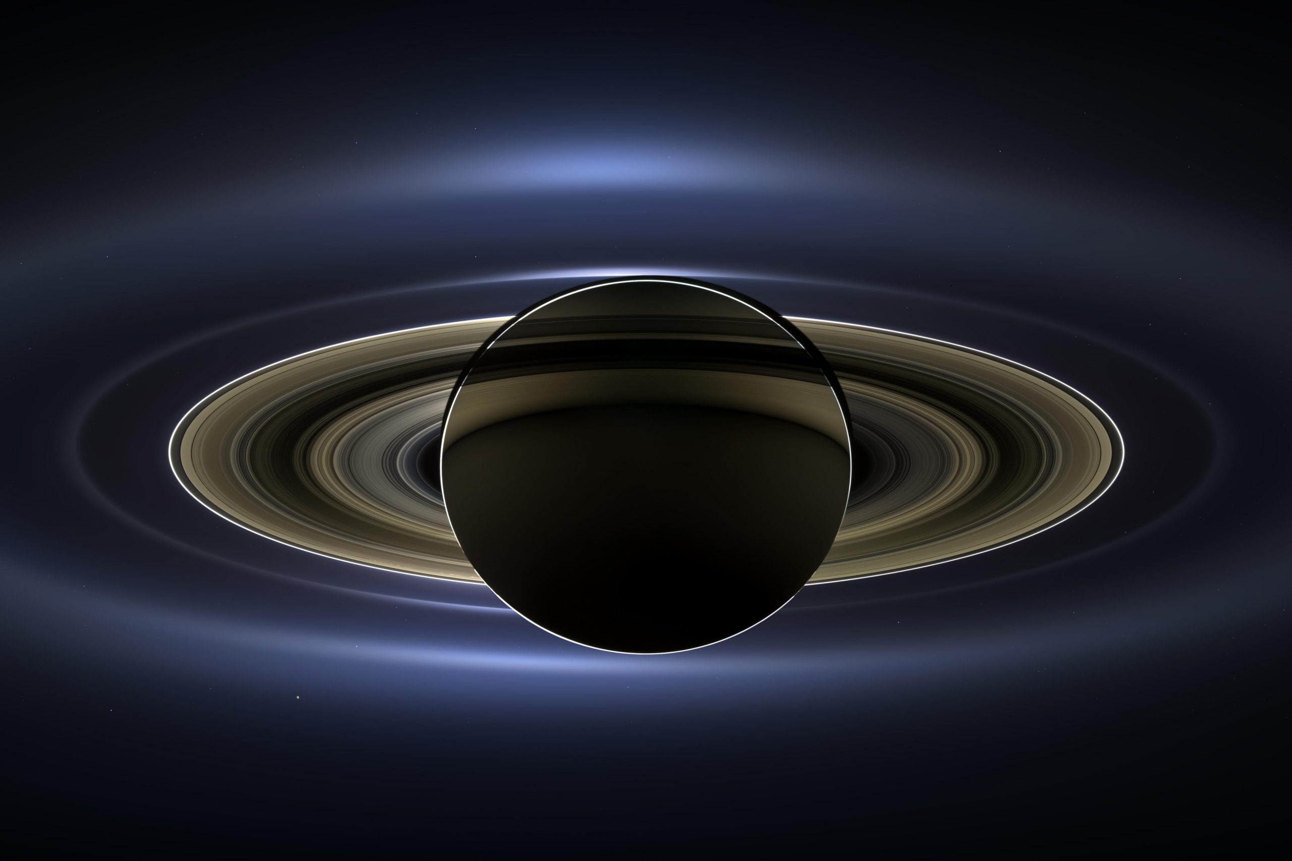 Saturn backlit by the sun, as seen by cassini in 2013. Earth can be seen as a few bright pixels below the right hand side of the rings.