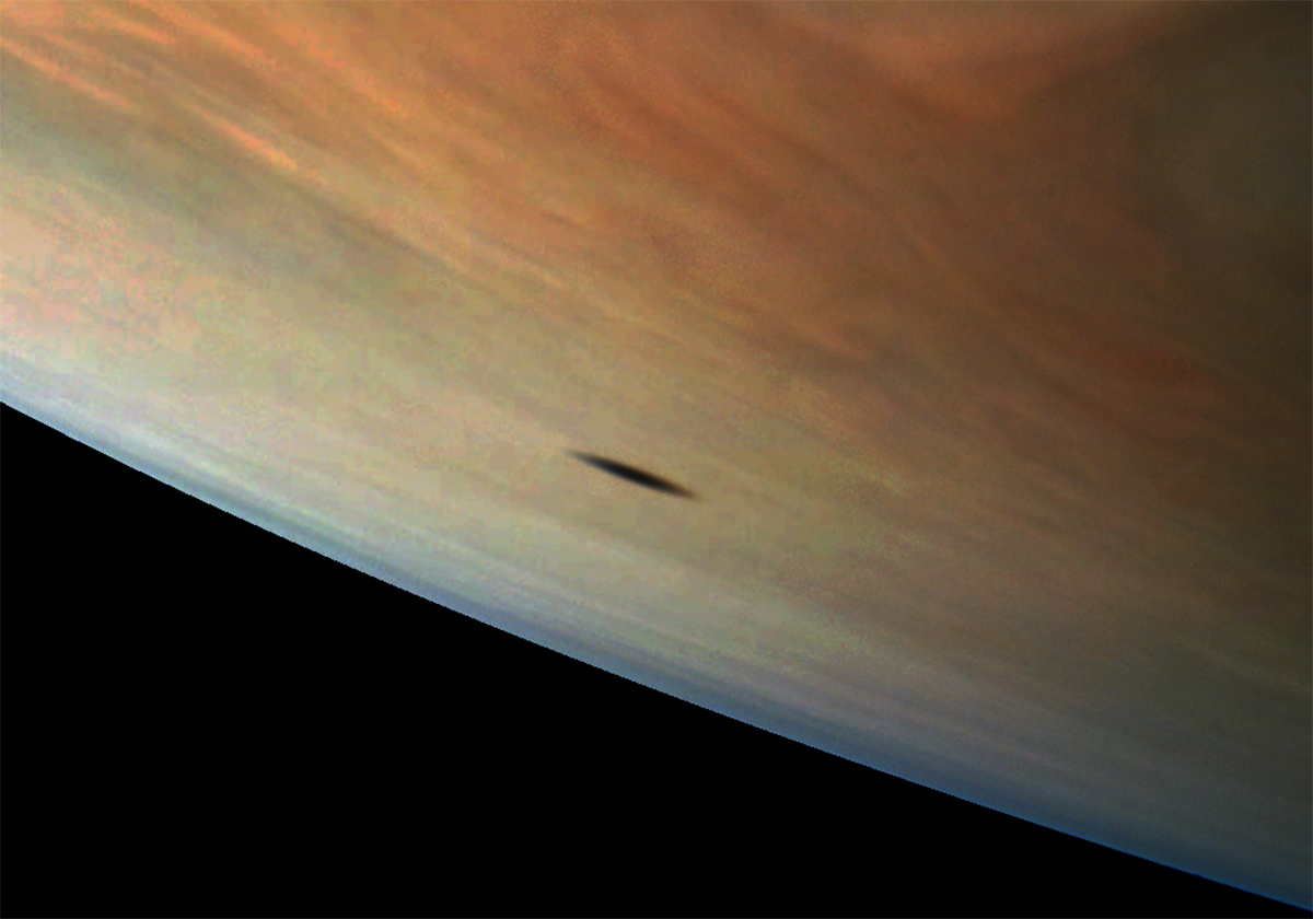 Jupiter’s moon amalthea casts a shadow on the clouds of the gas giant.