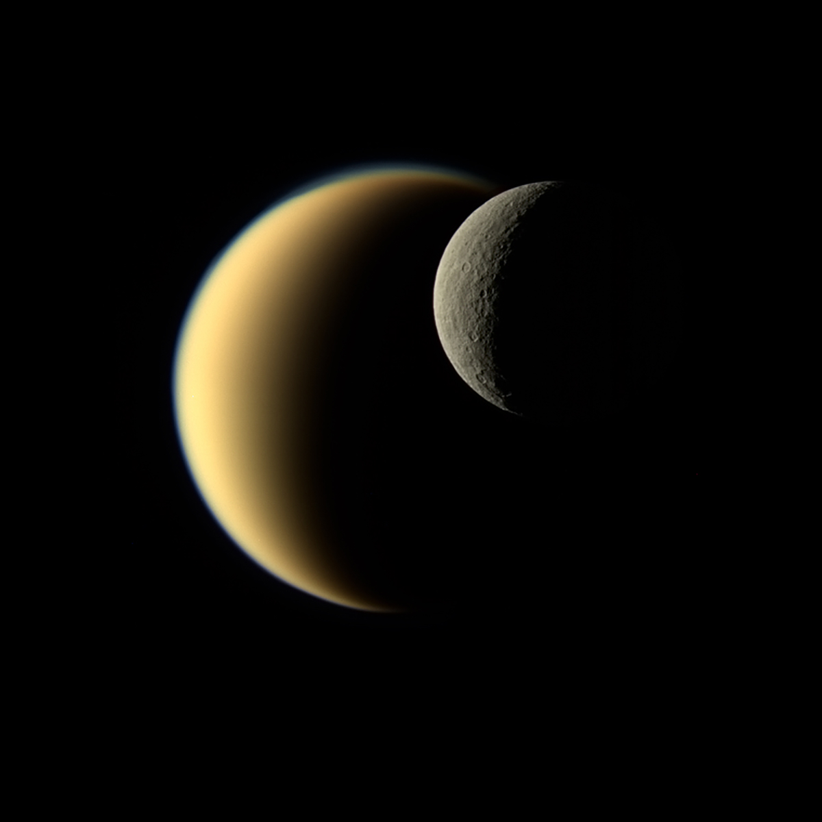 Saturn’s moon Rhea passes in front of Titan.