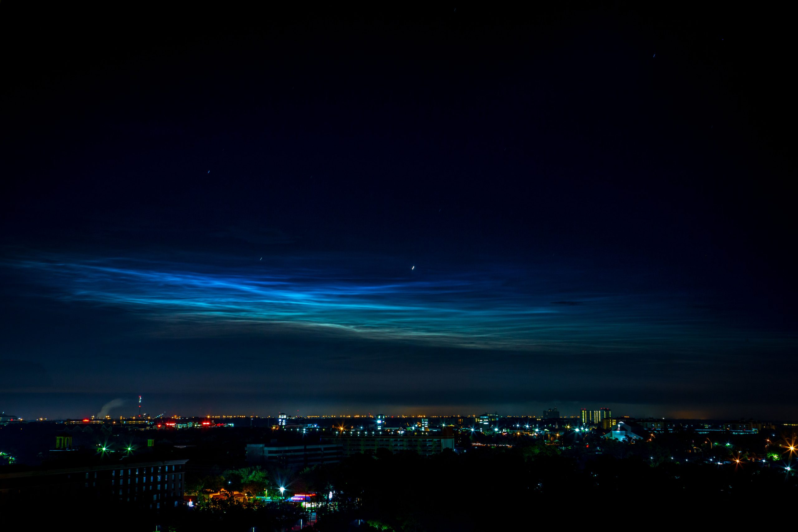 Noctilucent clouds over orlando, florida, in the aftermath of a rocket launch.