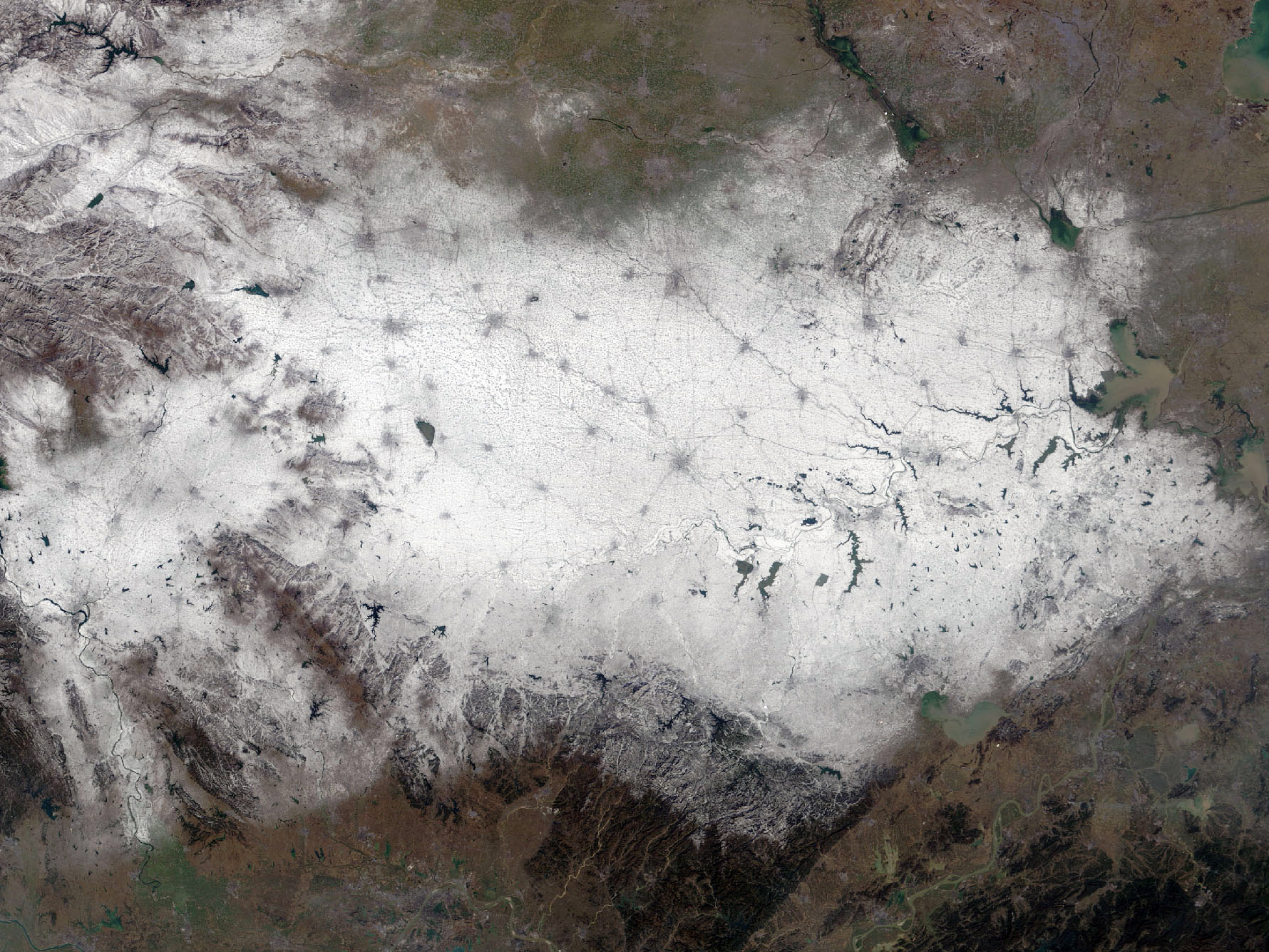 Snowfall in central china. Dark grey spots and lines are cities and roads.