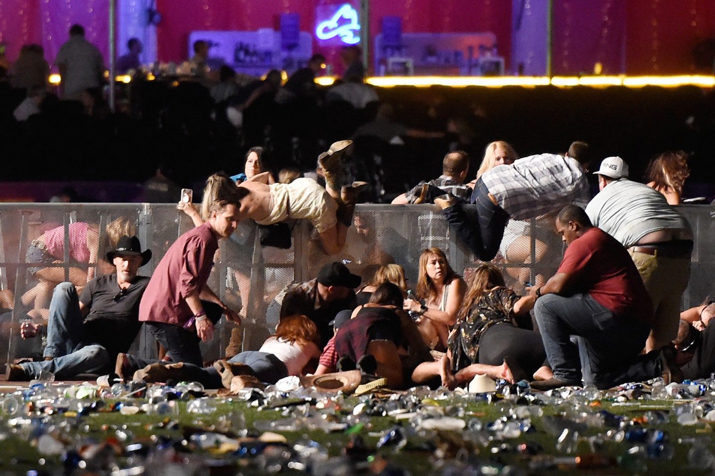 People dive for safety after gunman Stephen Paddock opens fire at a Las Vegas country music festival in October 2017.