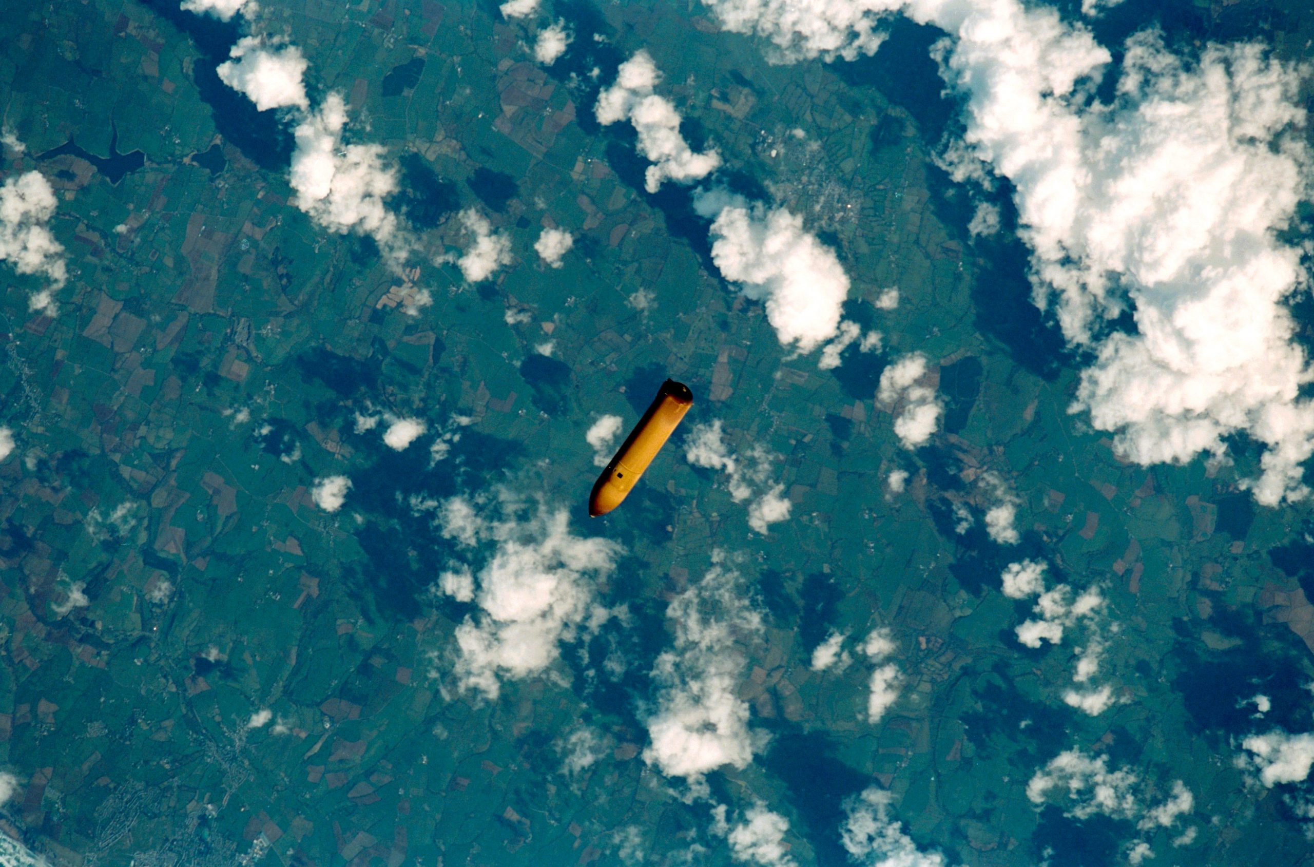 The external tank from sts-102 falls to earth.