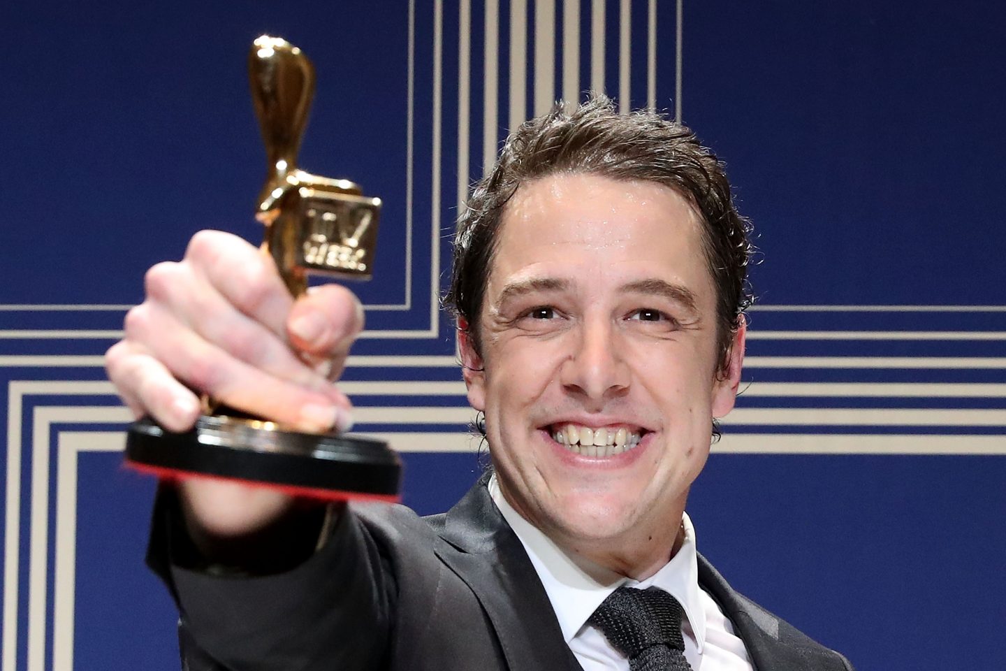 Australian actor and cancer activist Samuel Johnson poses with the annual Australian television award named after John Logie Baird.