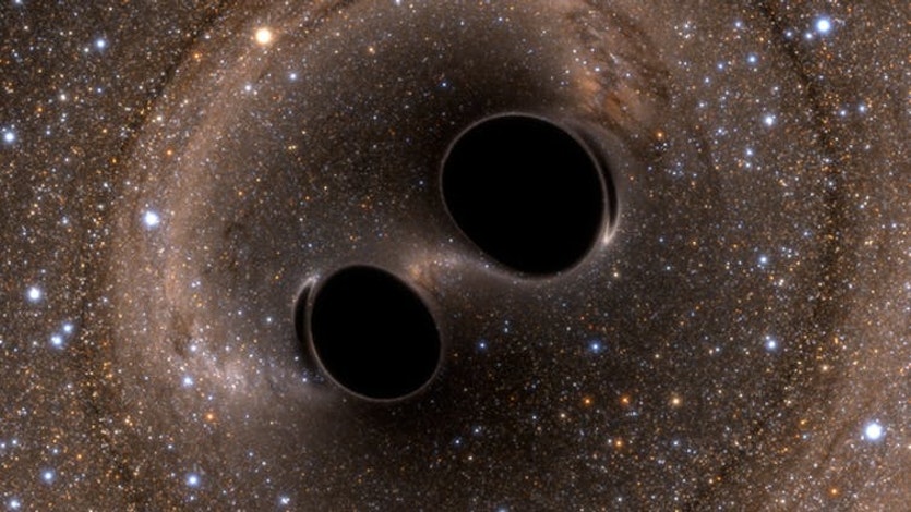 Black hole collision and merger releasing gravitational waves.