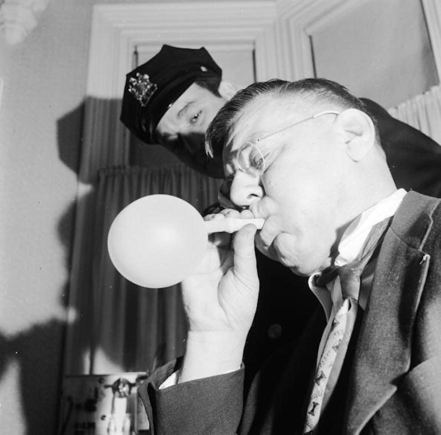 In a picture taken in 1955, a suspected drunk driver is tested using the drunkometer.