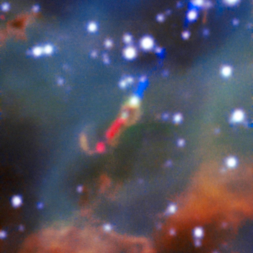 Seen in red here, the jet emitted by a fledgling star in the Large Magellanic Cloud.