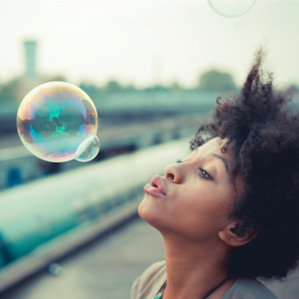 girl blowing bubbles