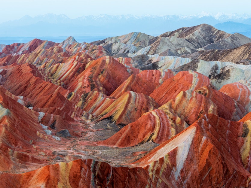 The layer-cake hills of zhanyge danxia are the product of 24 million years of tectonics and erosion.