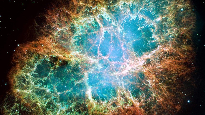The rapidly spinning neutron star embedded in the center of the Crab nebula is the dynamo powering the nebula's eerie interior bluish glow.