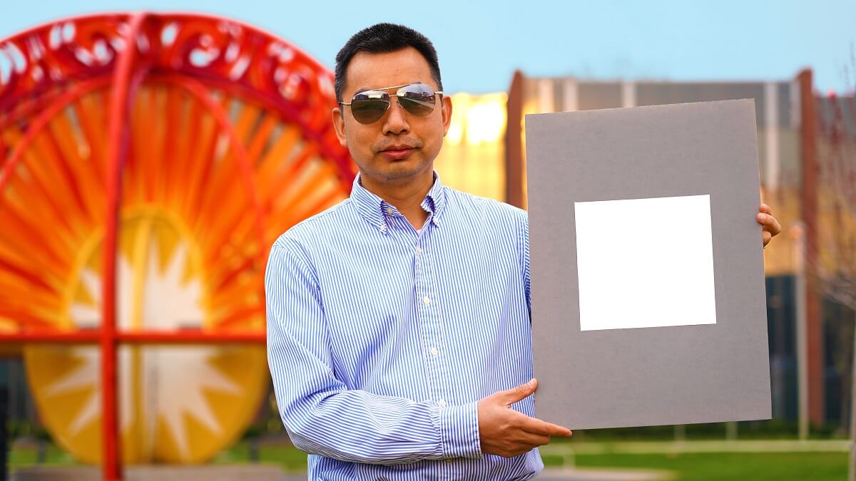 Xiulin Ruan holds up a sample of the whitest paint
