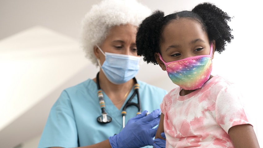 Healthcare Worker Giving a Vaccination Shot to a Young Girl