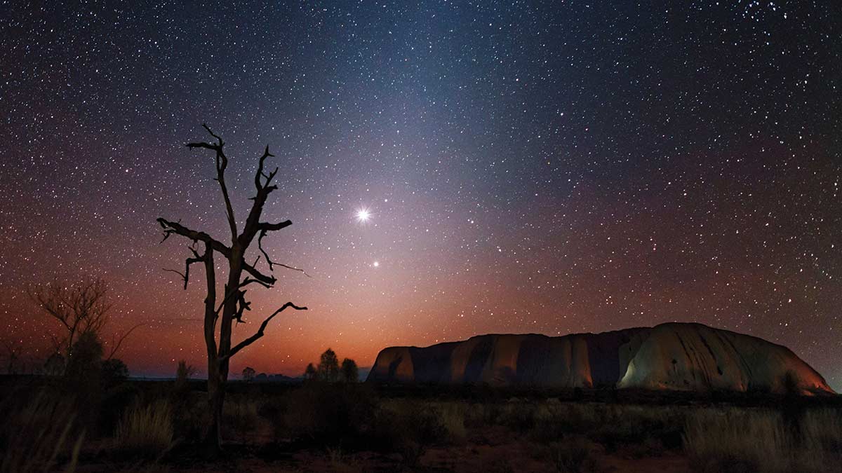 over Venus over Uluru, trailed by Jupiter in the early evening zodiacal dust light