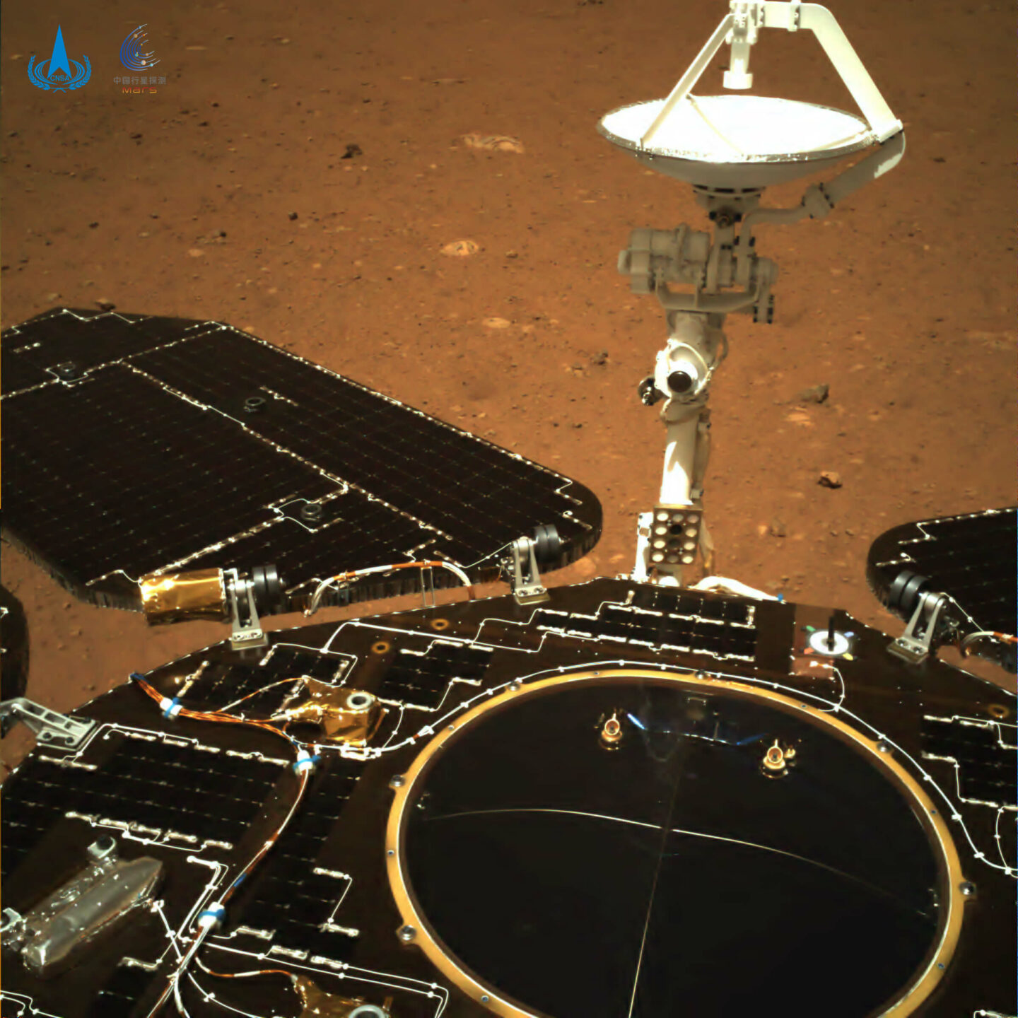 A machine with wings and a satellite. It is black. There is red soil in the background. this is not an image of the time when the sound recording sent back by zhurong was taken