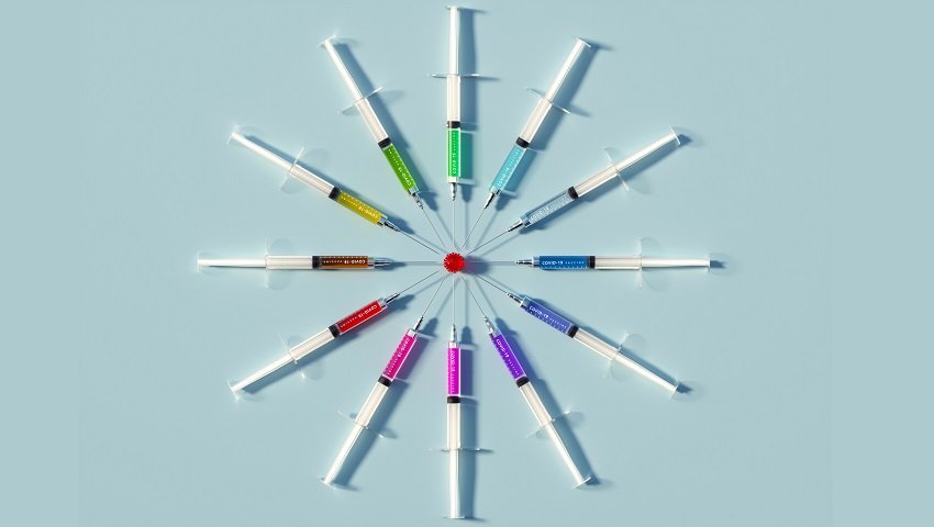 Digital generated image of circular pattern made out of Syringe with multi colored COVID-19 vaccine on blue background.