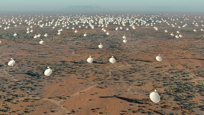 Artist's impression of the 5km diameter central core of Square Kilometre Array (SKA) antennas. There is a large orange dirty area. Hundrests of white dishes are on the ground. The sky is blue