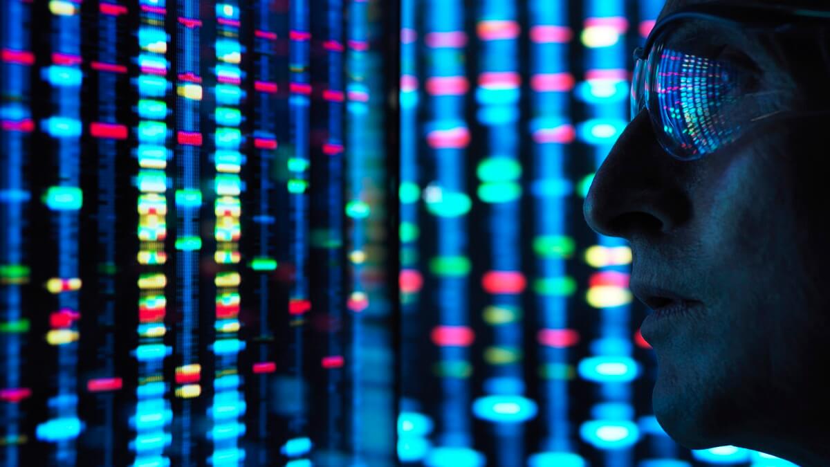 A scientist examining DNA sequences on a screen.