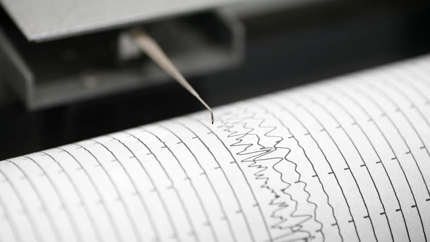 A seismometer recording tremors on paper.