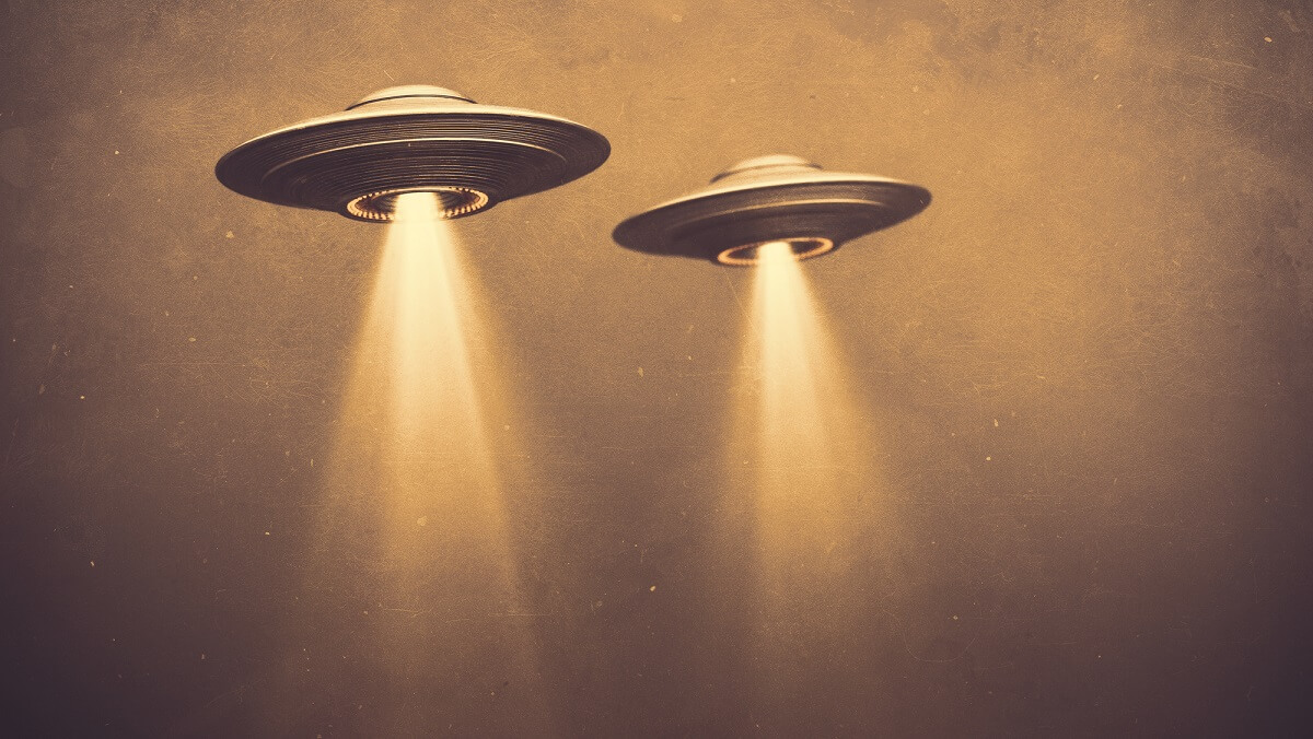 illustration of flat disk UFOS with light beams coming out the bottom