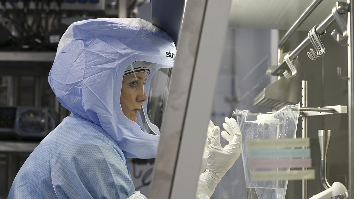 Photograph of woman in PPE working in the BioNTech Covid-19 Vaccine manufacturing facility in Germany