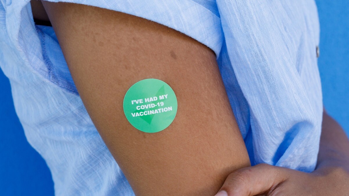 An arm with a sticker that says I have had my covid 19 vaccination