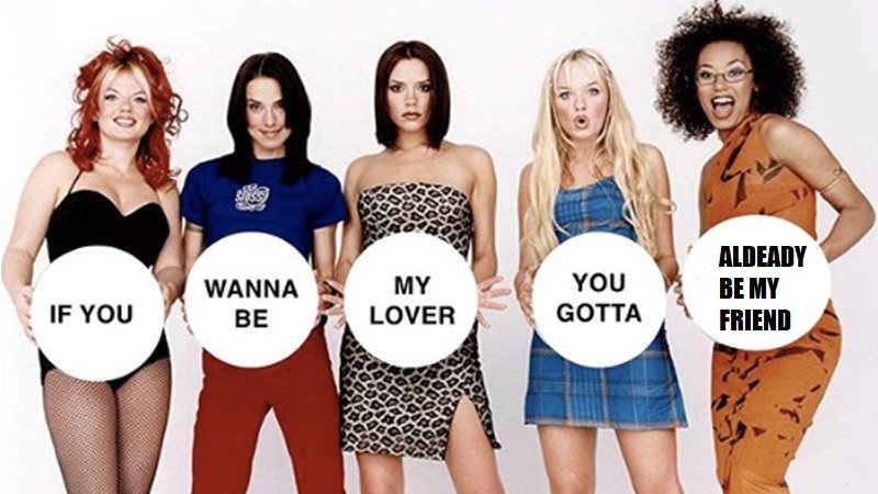 The spice girls holding signs that say "if you wanna be my lover you gotta already be my friend"