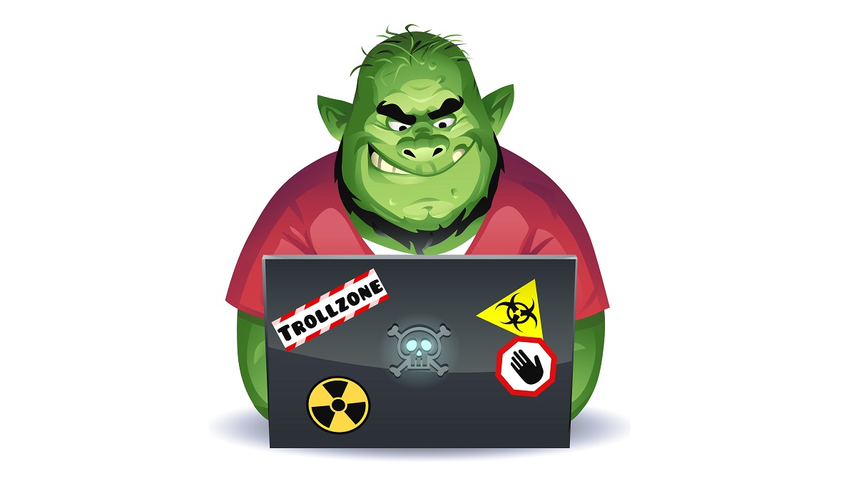 Vector illustration of a green overweight troll with a beard using a laptop computer, probably posting mean comments on social media. Concept for online trolling, cyberbullying, online harassment, rudeness, social media and communication.