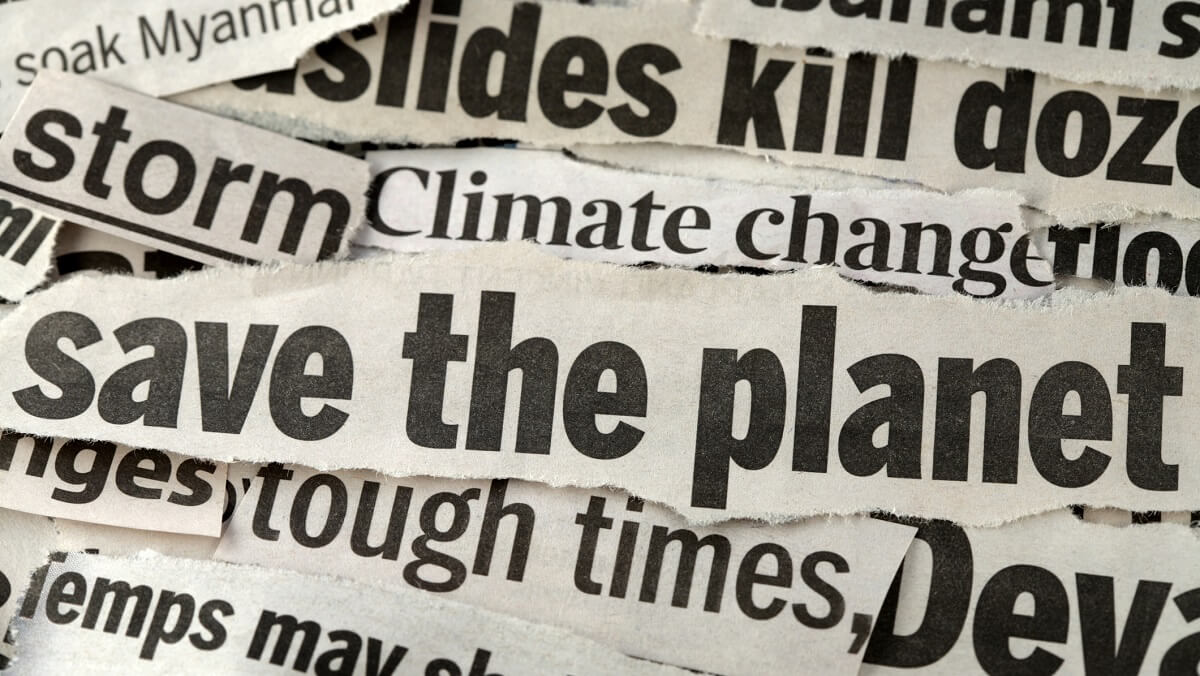 Stips of news paper that have words about climate. The one on top says save the planet