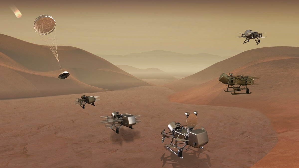 3D illustration of the Dragonfly mission with several robotic flying craft on a red hilly surface.