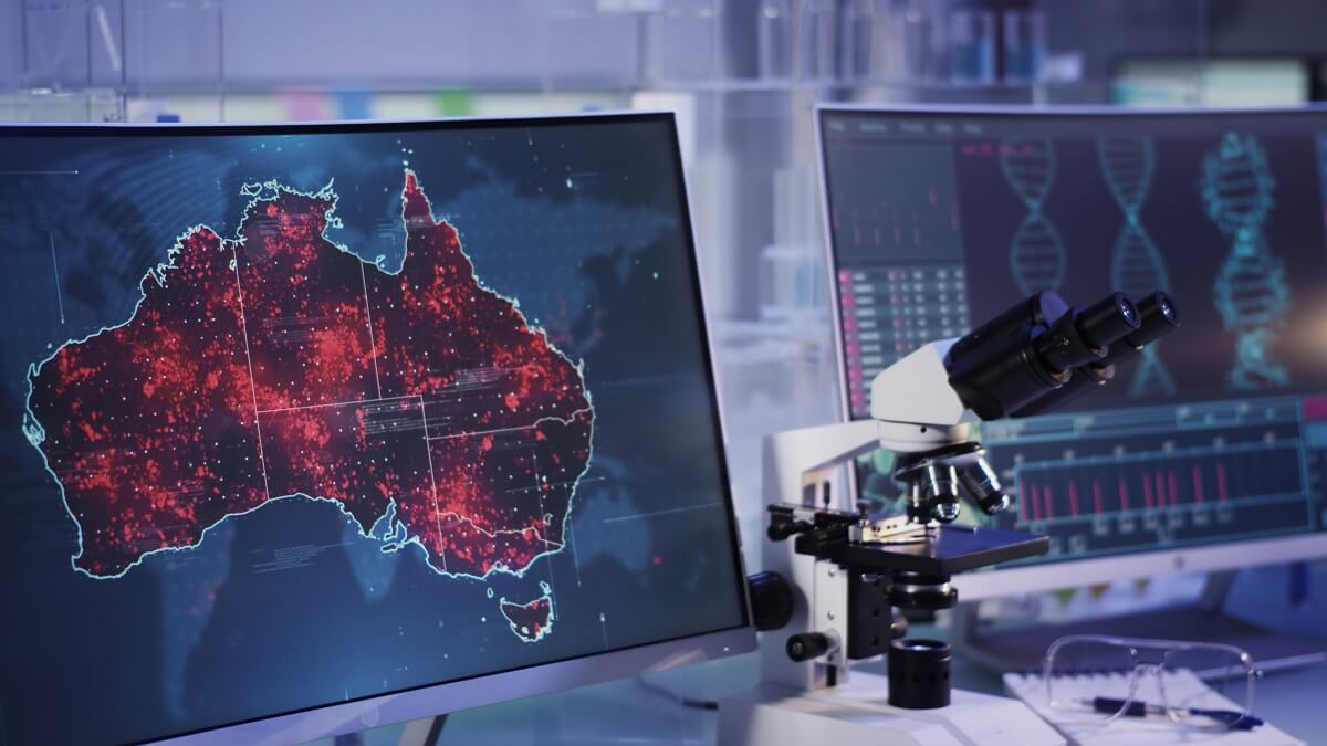 high-tech map of australia on a computer next to a microscope