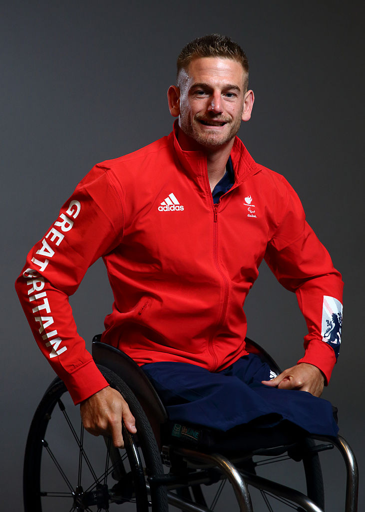 A man in a wheelchair poses for a portrait