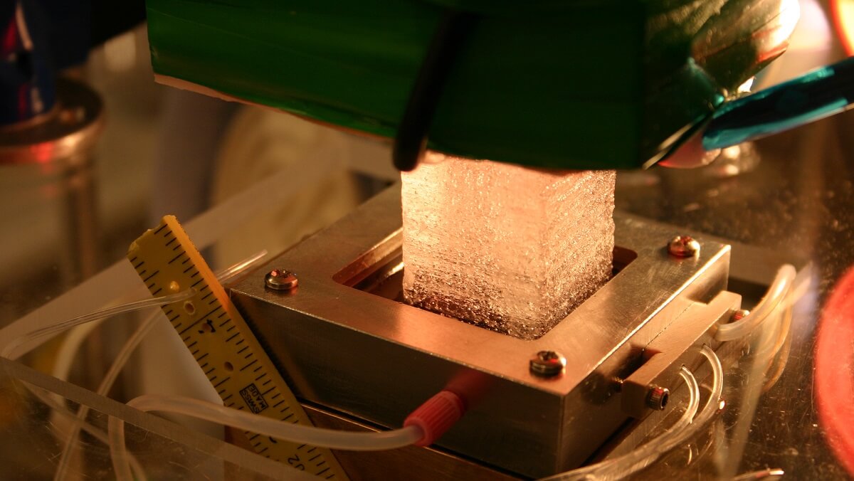 a square piece of ice being inserted into a machine