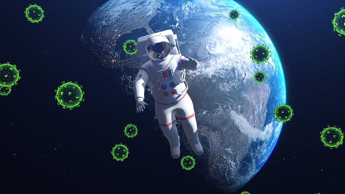 an astronaut in space with the earth behind them. There are green microbes around them