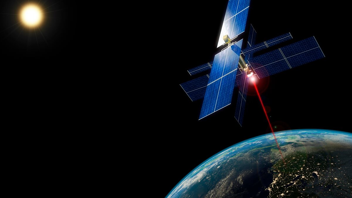 A satelite in space with a red beam that is point at earth. There is a sun in thebackground