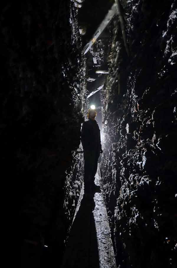 Man standing in a dark tunnel