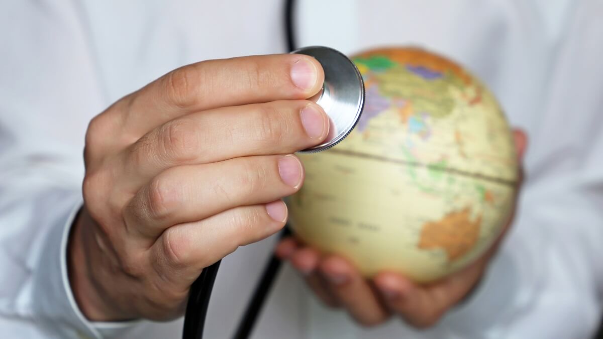 photo of doctor holding globe with australia on it