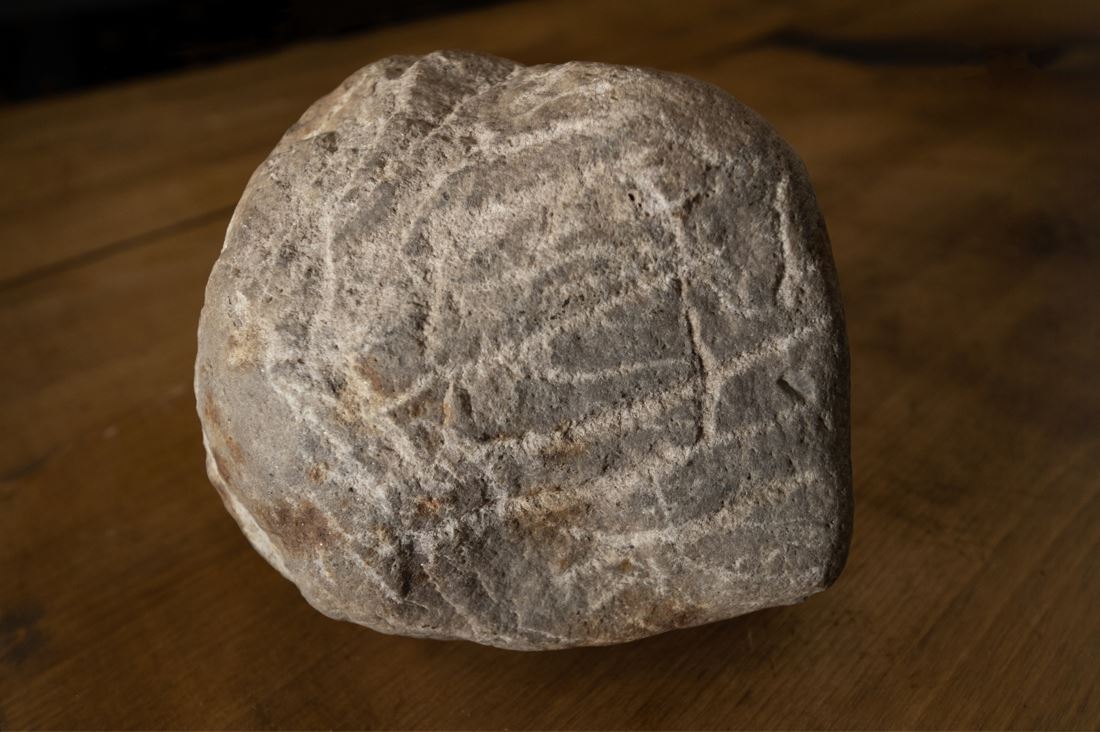 A stone with lines craved into it