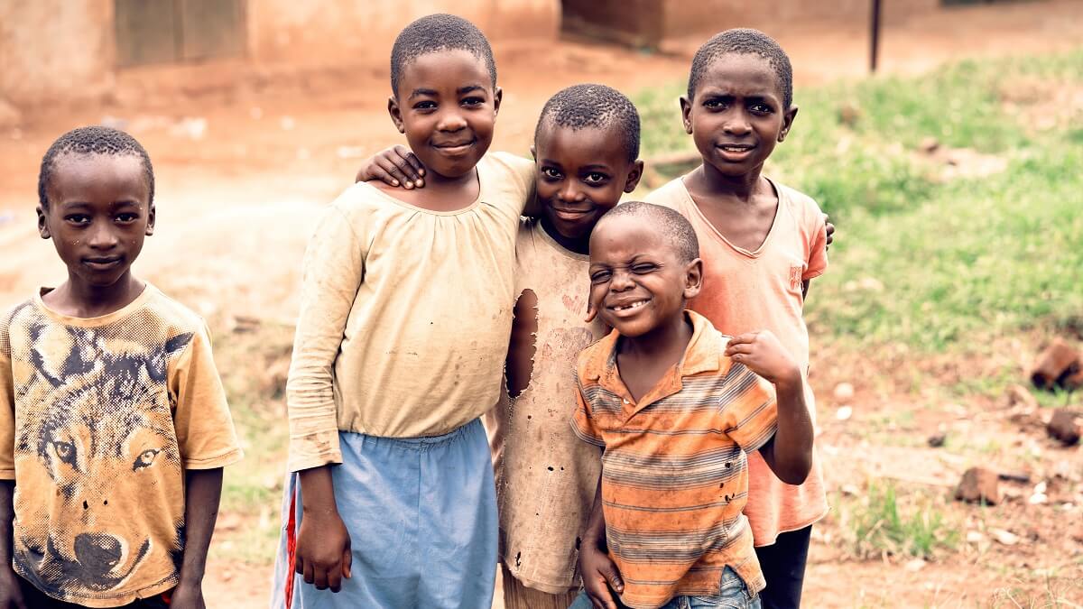 Five young boys smile at camera