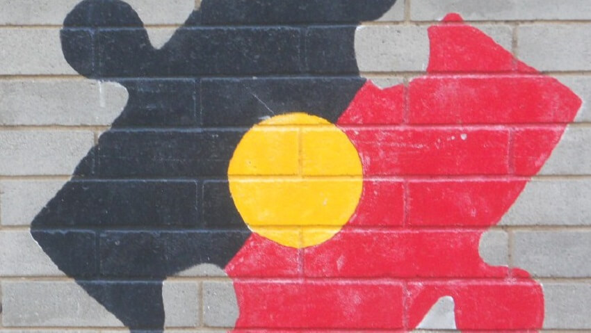 Painting of indigenous flag on brick wall