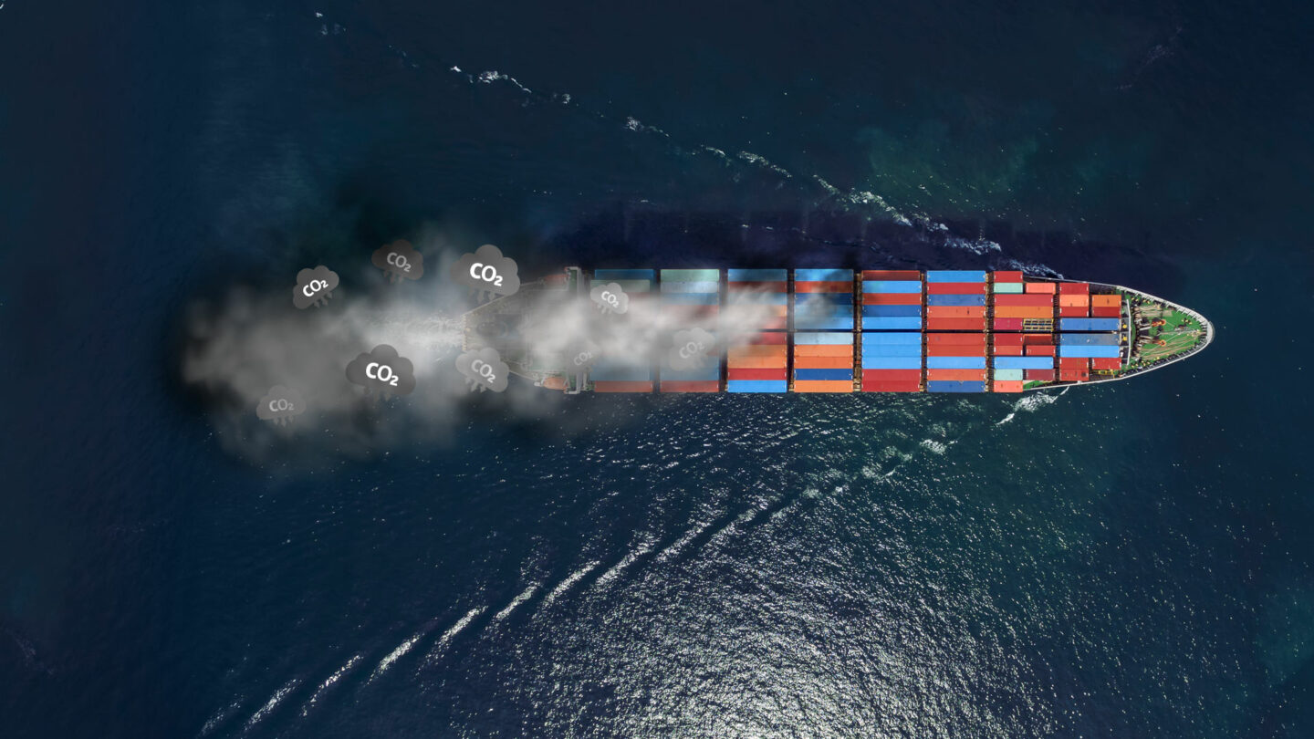 aerial view of a cargo ship emitting CO2