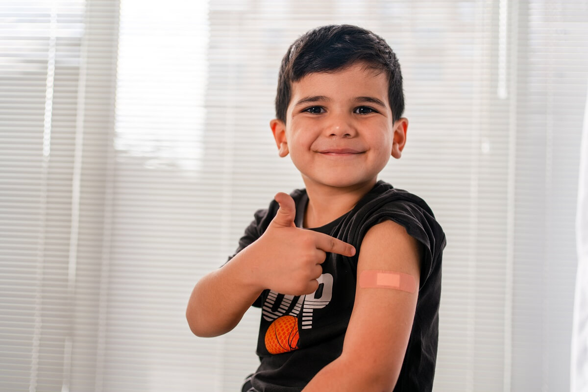 Vaccinated child showing shoulder after shot