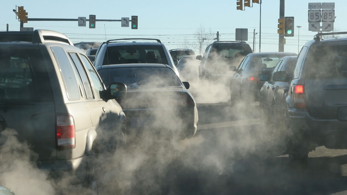 air pollution and fumes rising from cars in a queue