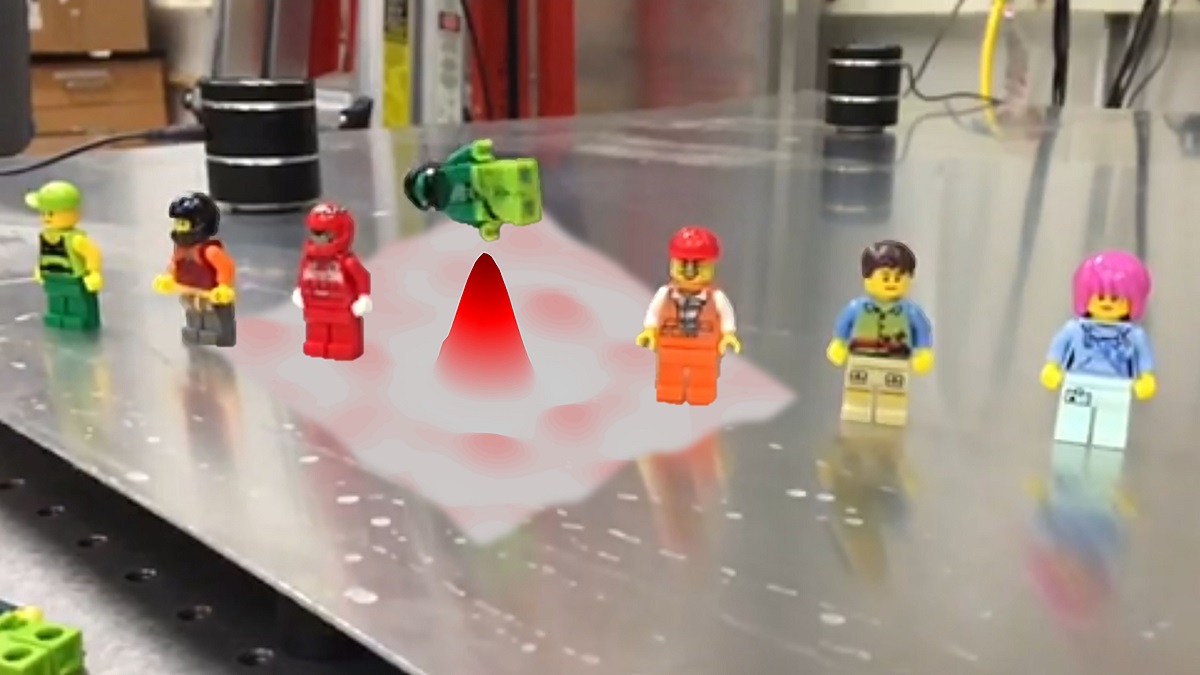 lego figures standing on a table. One is in the air