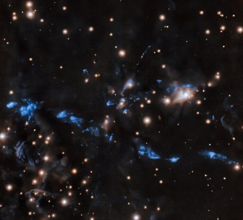 Blue fragmented jet on field of stars
