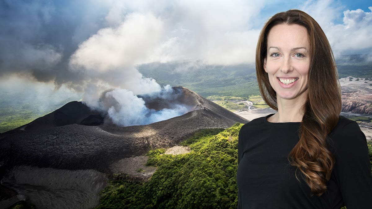 heather handley in front of a landscape with a smoking volcanic eruption